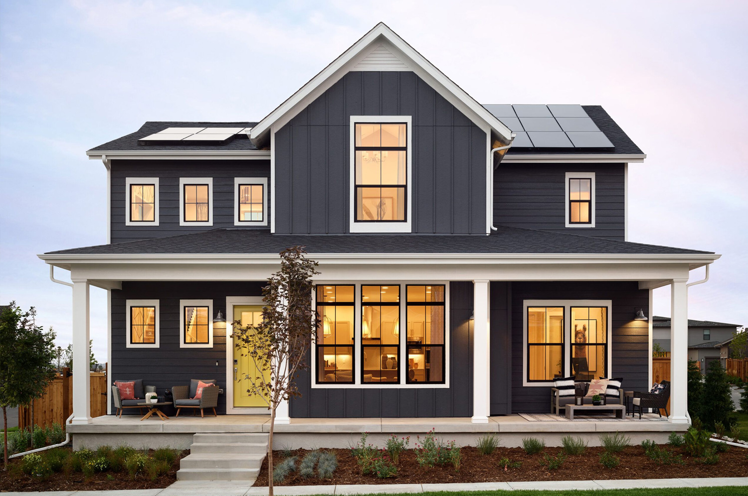 Picture of the Exterior of a Blue Home With Solar Panels on It